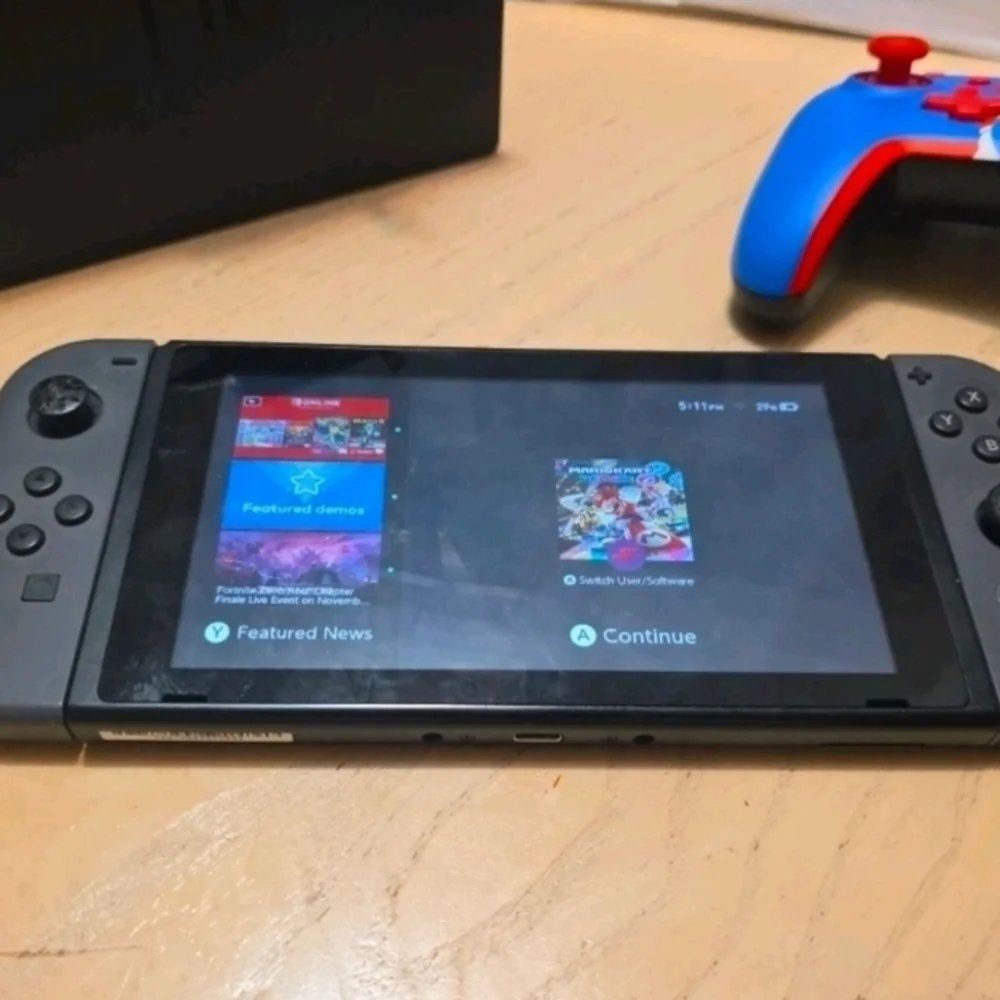 Nintendo Switch with Black Pro Controller and Blue Red Wired Controller
